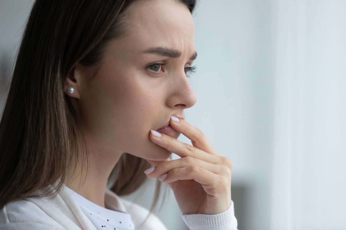 Anxious young woman thinking of personal or health problems.